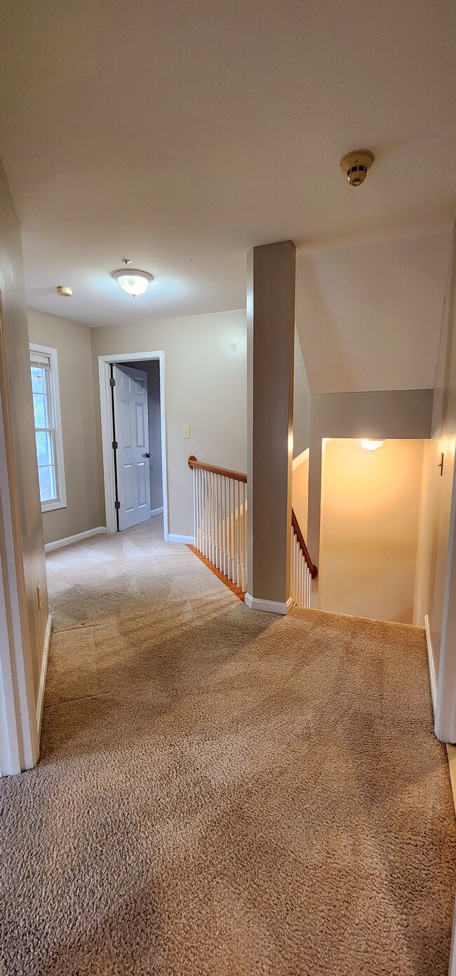 Light-filled landing connecting all 3 upstairs bedrooms and shared bathroom - 13 Steeple Ct