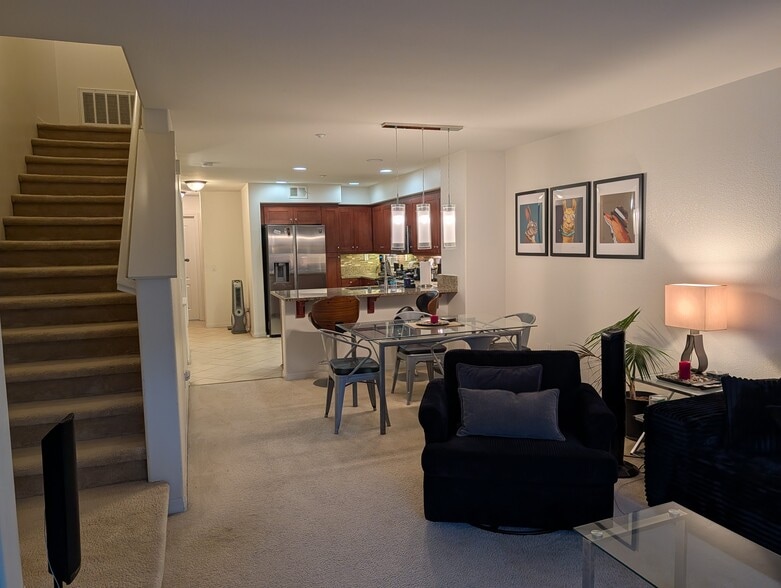 View from living room area facing towards dining and kitchen area. Stairs lead to 3rd floor bedrooms - 3542 Shoreline Bluff Lane