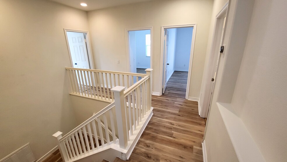 Upstairs hallway showing entrances to three bedrooms - 4317 Palazzo Ln
