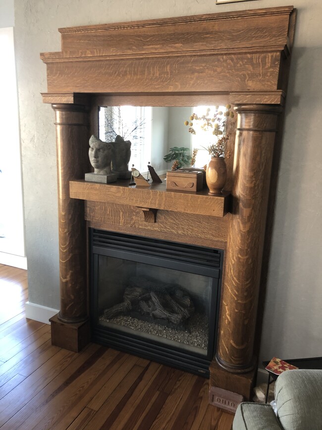 Gas fireplace with hand crafted mantle surround - 14 E 1st St