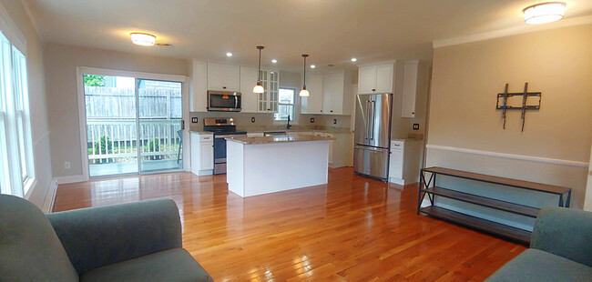 Living area view two, unfurnished, with recessed lighting, built in microwave, and ample storage - 819 Page St