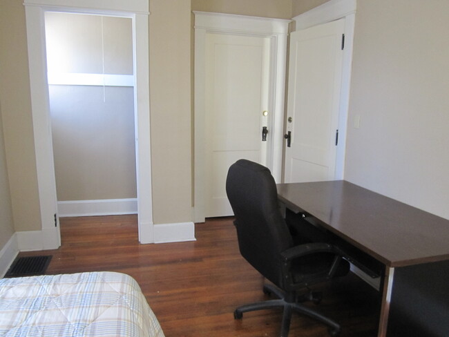 The bedroom as seen from the northeast toward the walk in closet. The mirror, twin bed and dresser are included. The desk and chair have been removed. - 1525 South 7th Street