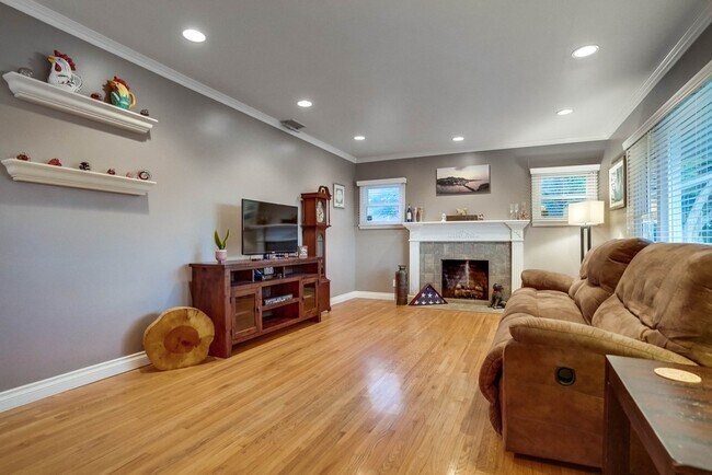 Living Room with a custom fireplace and ample natural light - 1340 W 3rd St
