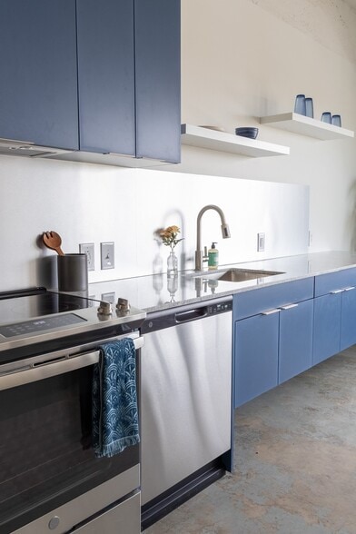 Kitchen with custom cabinetry - Lofts at the Mac