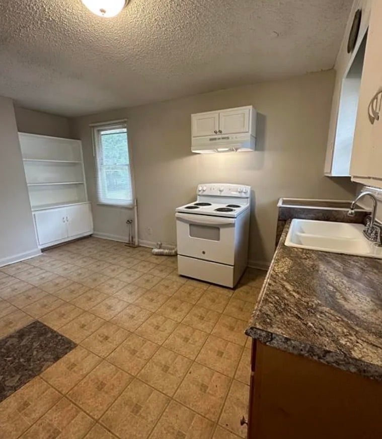 Kitchen with stove and refrigerator. New washer and dryer included. - 110 Rebecca St