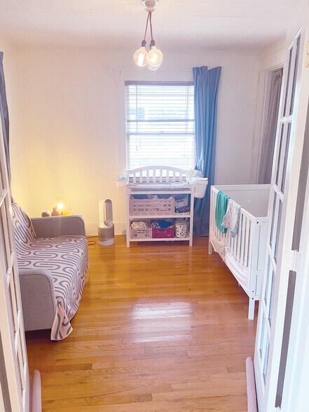 French doors offer flexibility: 2nd bedroom (or leave french doors open as larger living room) - 5124 NE 35th Pl