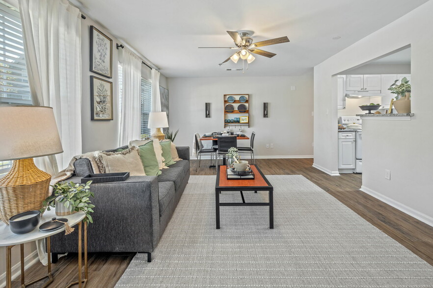 Contemporary Living Room with Wood-Style Flooring and Ceiling Fan - Theater Street Apartments