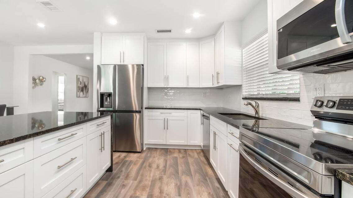 Kitchen facing south. - 121 George Bush Blvd