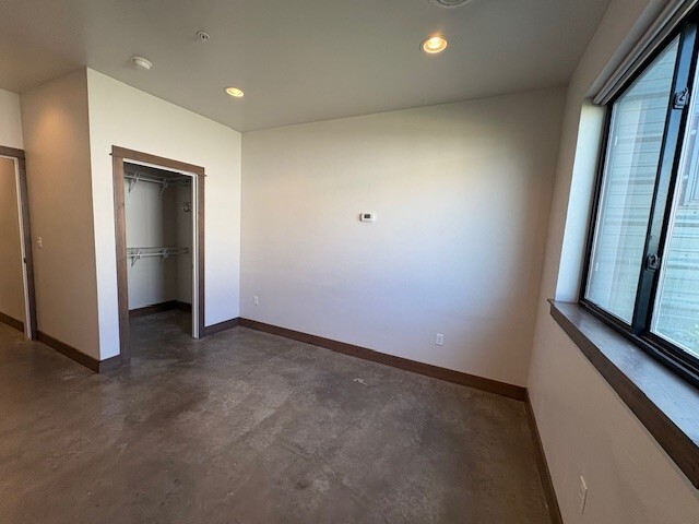 bedroom with widow to right and walk in closet to the left - 49 Intrepid Dr
