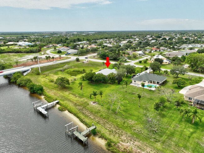 Building Photo - A BOATER'S PARADISE WITH THIS STUNNING 3 BEDROOM, 2 BATH WATERFRONT POOL HOME W/DOCK & BOAT LIFT ...