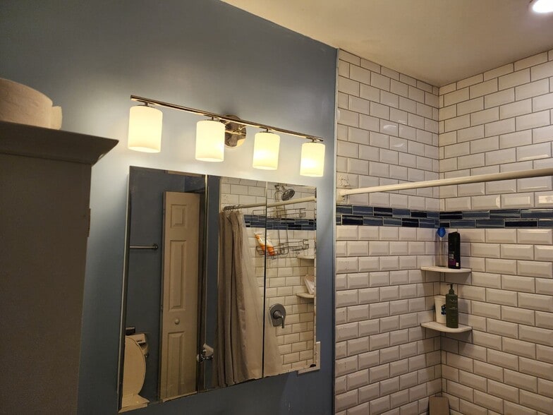 Bathroom featuring new amenities and new tile work - 601 Delaware St