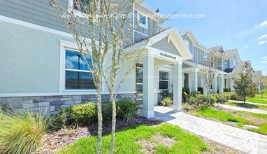 Building Photo - EXCEPTIONAL AND SPACIOUS FURNISHED TOWNHOME WITHIN WATERSIDE- NAUTIQUE!