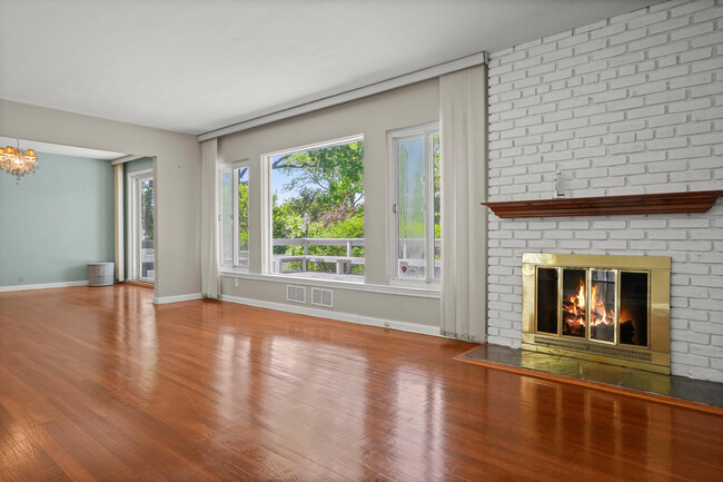 Living room with large picture windows and working fireplace. - 319 Davenport Ave