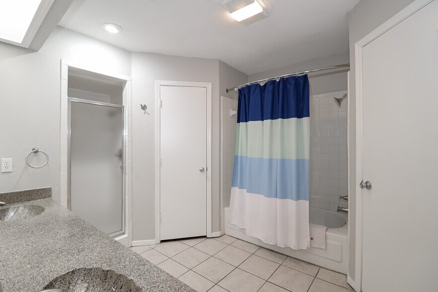 Master bath features a dual sink vanity, two (2) walk-in closets, shower stall, and bathtub shower - 2507 Holt Road