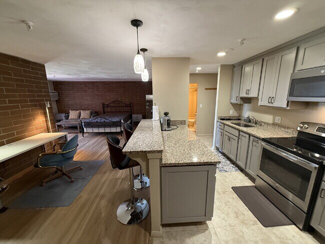 Building Photo - Modern & furnished studio unit available NOW!