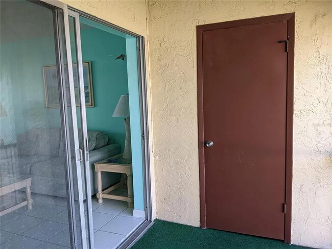 PORCH WITH TABLE - 7701 Starkey Rd