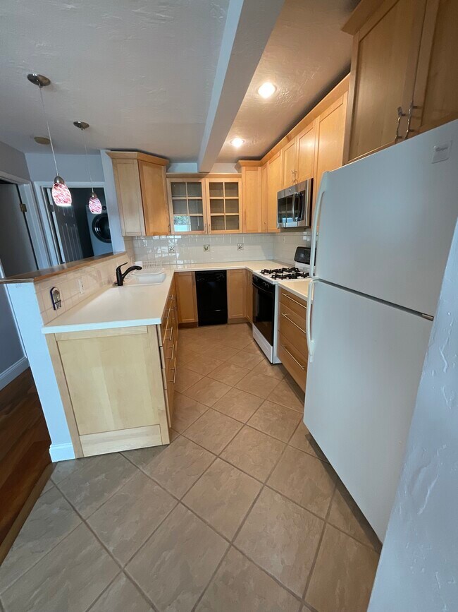 Kitchen has maple cabinets with dishwasher, disposal, gas stove/oven and microwave - 2452 Harding Ave