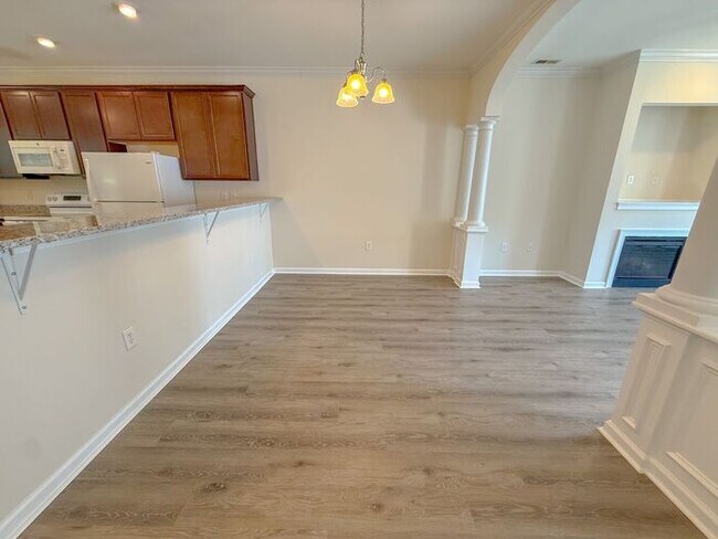Building Photo - Beautifully updated Townhome! New cabinets, granite counter tops, and LVP flooring through downst...