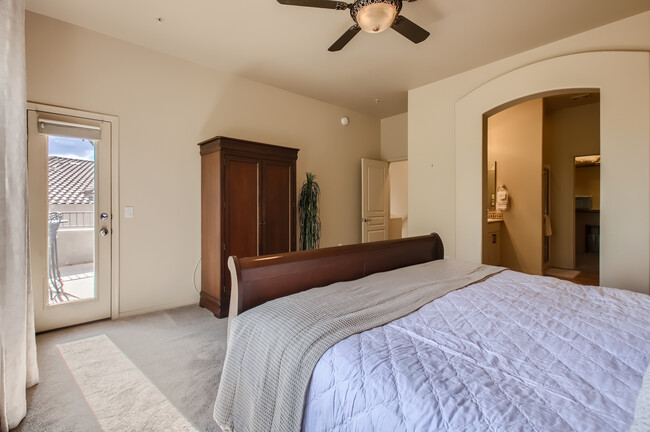 Primary bedroom with side door to upper balcony for mountain views - 19475 N Grayhawk Dr