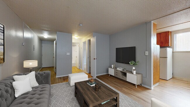 Experience comfort in this chic living area, where style meets functionality. - Harmony Apartments
