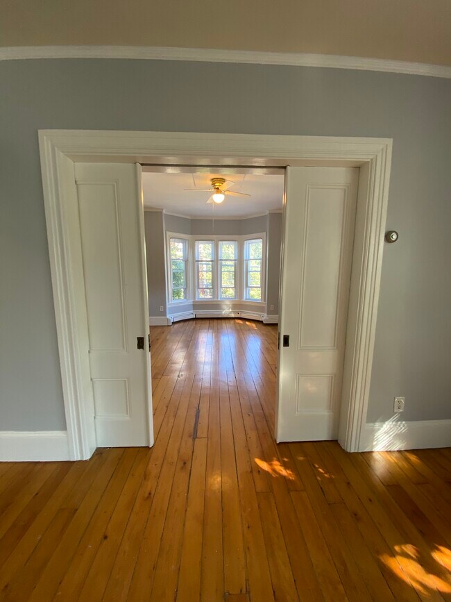 Front parlor/living room with pocket doors slightly closed - 86 Holden St
