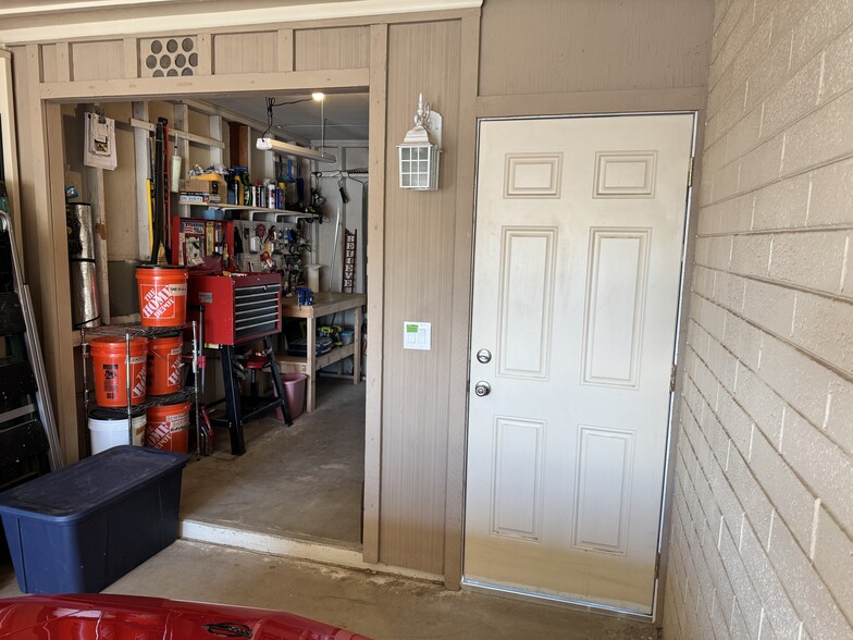 Door inside garage leading to covered patio - 11402 N 110th Dr