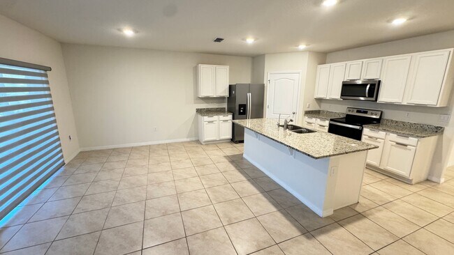 Building Photo - Available NOW! Spacious 4BD/2BA Haven in Villages at Harmony – Your Dream Home Awaits! WASHER & D...