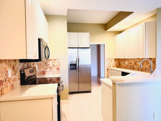 Building Photo - Experience Bell Tower Park. GATED ground floor 2 Bed 2 Bath Den 1 Car Garage Condo.
