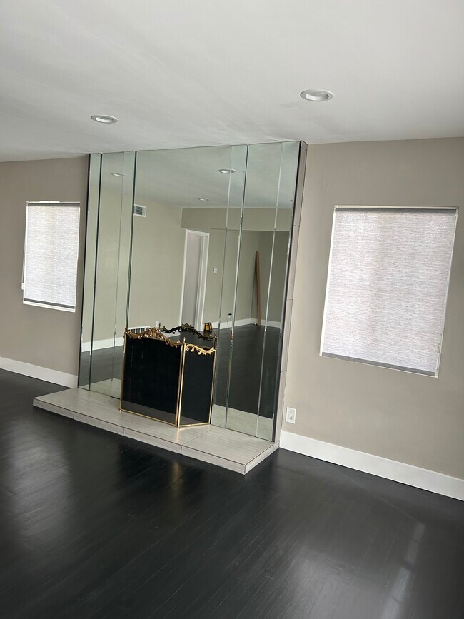 New living room with hardwood floors and custom window covering - 5303 W Slauson Ave
