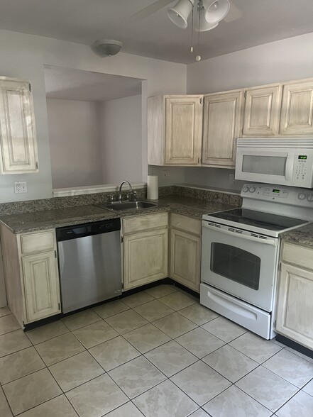 granite counter top with range, dishwasher and refrigerator - 85 Riverview Pl