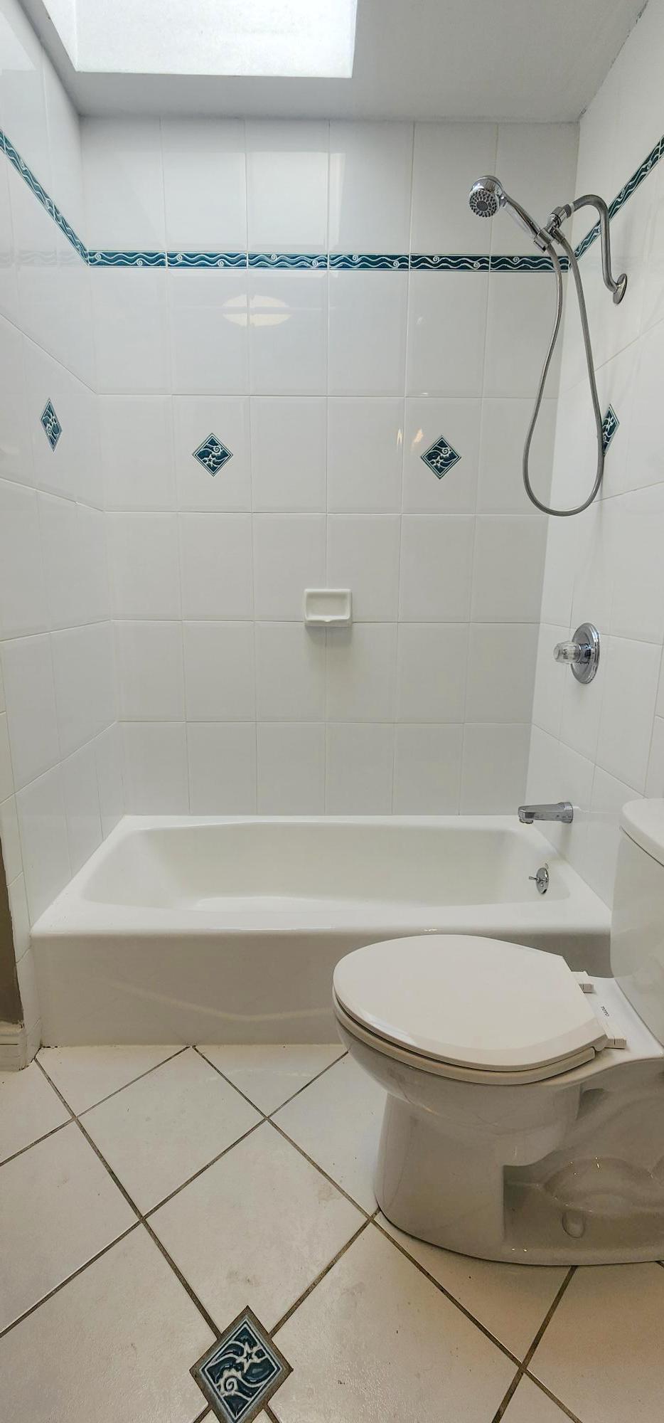 Bathroom detail with matching tile on floor and shower sides - 245 Concord St