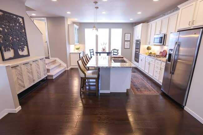 View from living room to kitchen on main level - 15637 E Broncos Pl