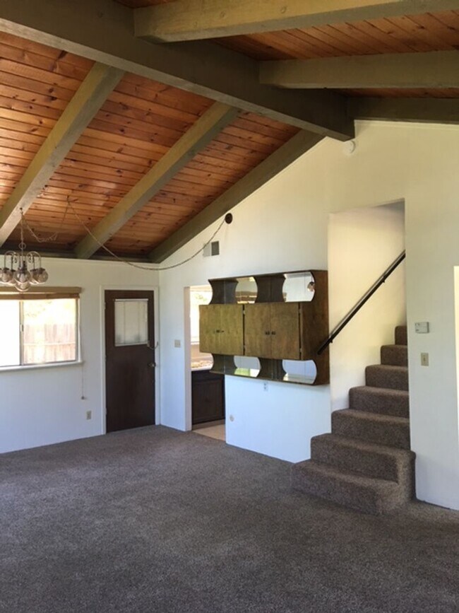 Building Photo - Downtown home with loft and exposed beam ceilings.