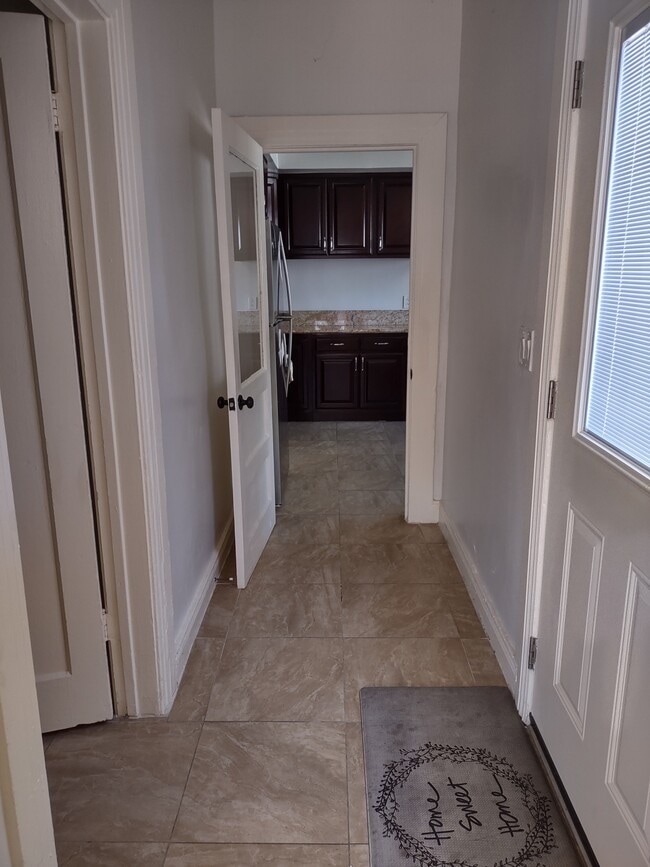 hallway from den to the kitchen. Bathroom on the left - 2142 S Victoria Ave
