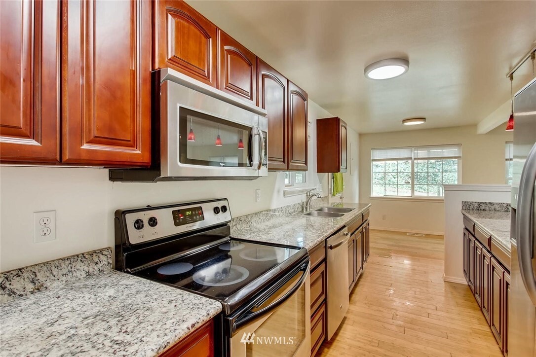 Shared kitchen and dining space have all new stainless steel appliances - 245 S 126th St