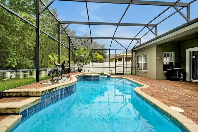 Building Photo - "Stunning Fully Furnished 3BR Orlando Home with Private Screened Pool, Spa & Spacious Living Areas"