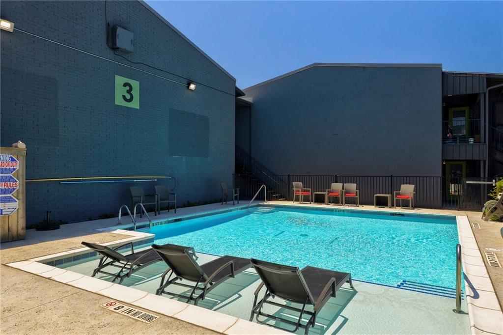The complex features a pool, complete with lounge chares and a grill. Perfect for summer! - 909 Reinli St