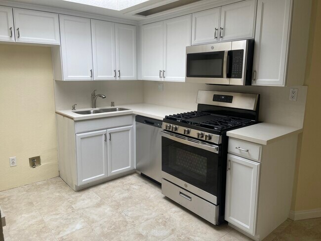 Renovated kitchen with brand new GE appliances, new sink, faucets, countertop and hardware. - 435 E Valencia Ave