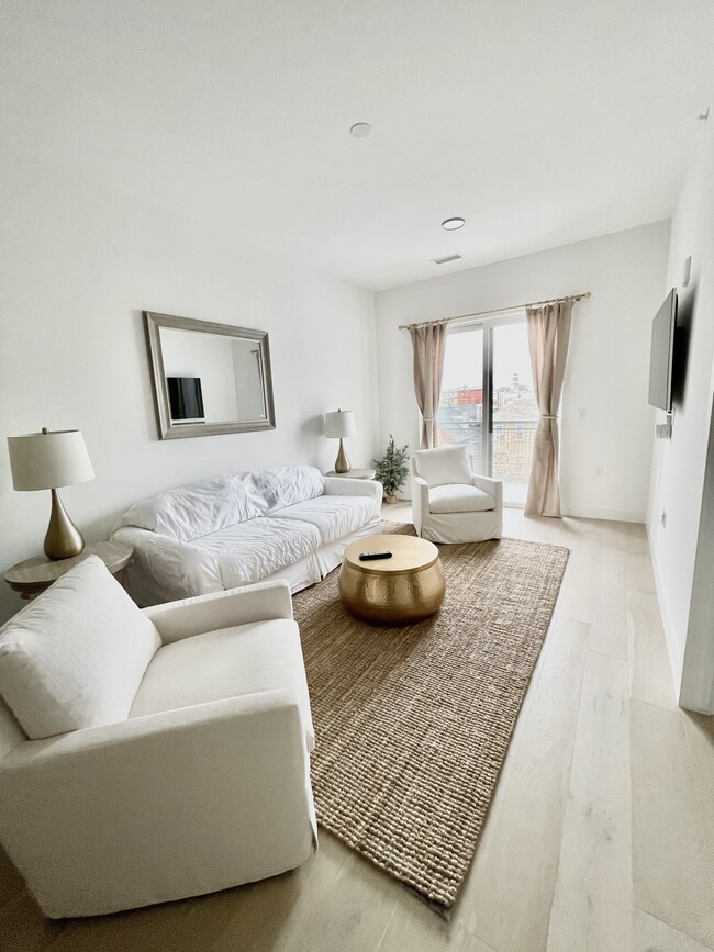 Living room during the daytime. Lots of light when the curtains are open. - 2530 Lawrence St