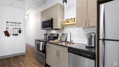 Our pet-friendly 1- and 2-bedroom industrial inspired lofts feature 9-foot, 4-inch ceilings with exposed structure and ductwork. Kitchens feature stone countertops and stainless steel appliances. - Wrigleyville Lofts