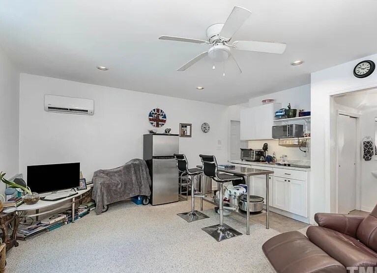 Combined living room & kitchen view (Heat/AC and w/d included) - 115 W Woodridge Dr