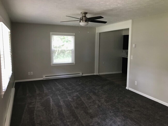 Living room with ceiling fan. - 874 A Pleasant Ridge Rd
