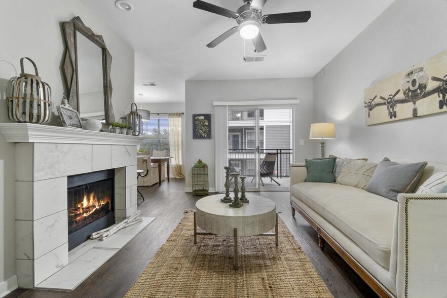 Newly Renovated Apartments and Townhomes with Upscale Wood Style Flooring and Expansive Windows with Abundant Natural Light - Flatiron District at Austin Ranch