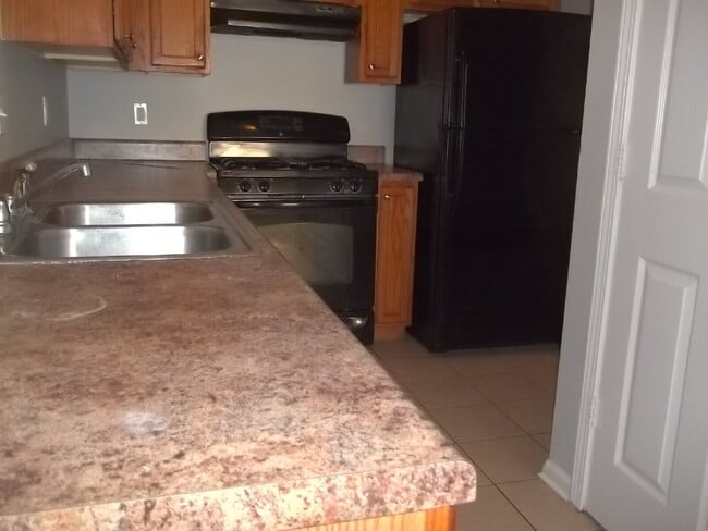Building Photo - Freshly painted and new flooring in this 4 Bedroom 2 and Half Bath home. Covered front porch with...