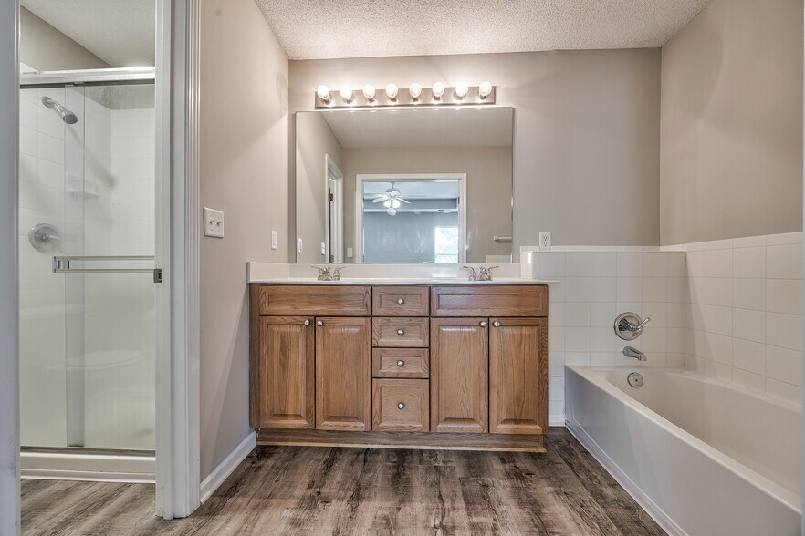 Primary bath with double vanity, tub, and separate shower/toilet room - 22810 West 71st Terrace