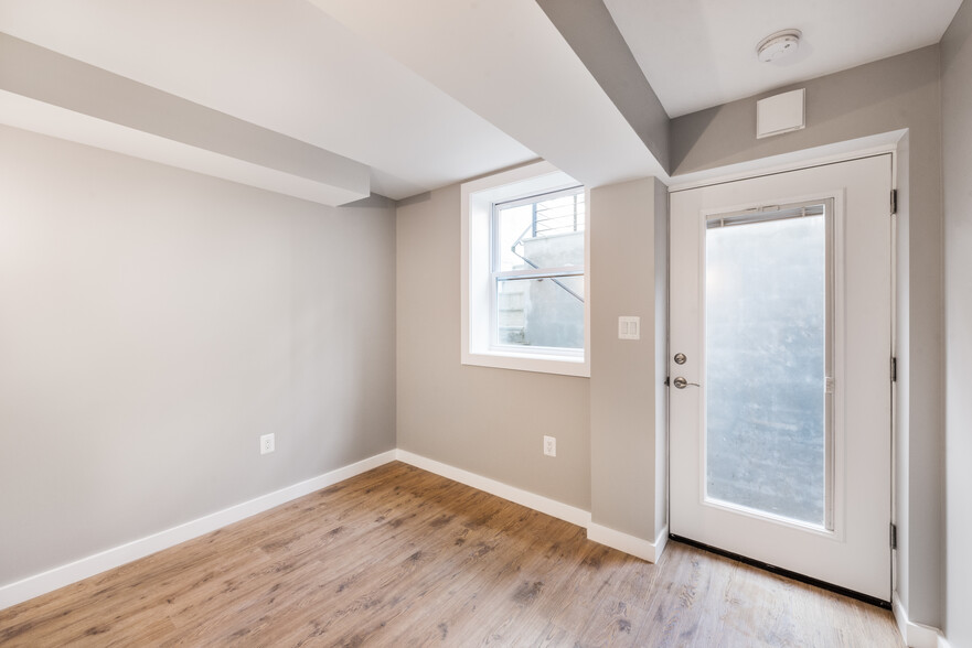 Bedroom with window and door with privacy blinds lets in lots of light. - 523A Irving St NW