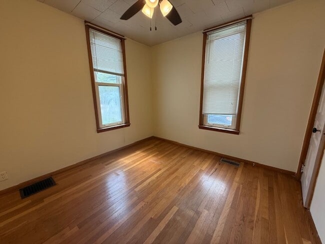 Building Photo - Classic Hardwood Floors, Fenced Yard & 2-Car Garage