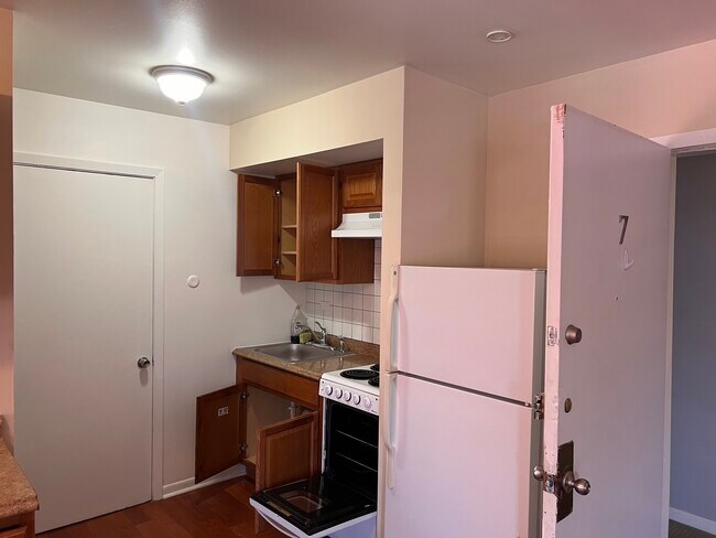 Kitchen area. Studio sized oven. Full Fridge - 7220 Madison St