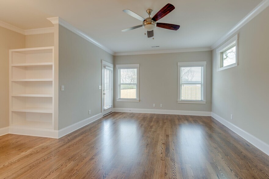 Large living room with builtin bookcase and back door - 562 Stevenson St
