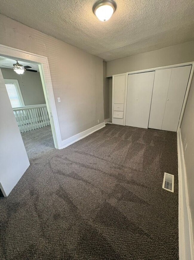 Building Photo - A cozy 2 bedroom home with versatile living space and plenty of storage including a partially fin...